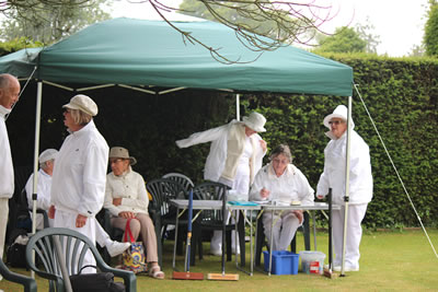 Time keepers, Scorers & Spectators sheltered from the drizzle